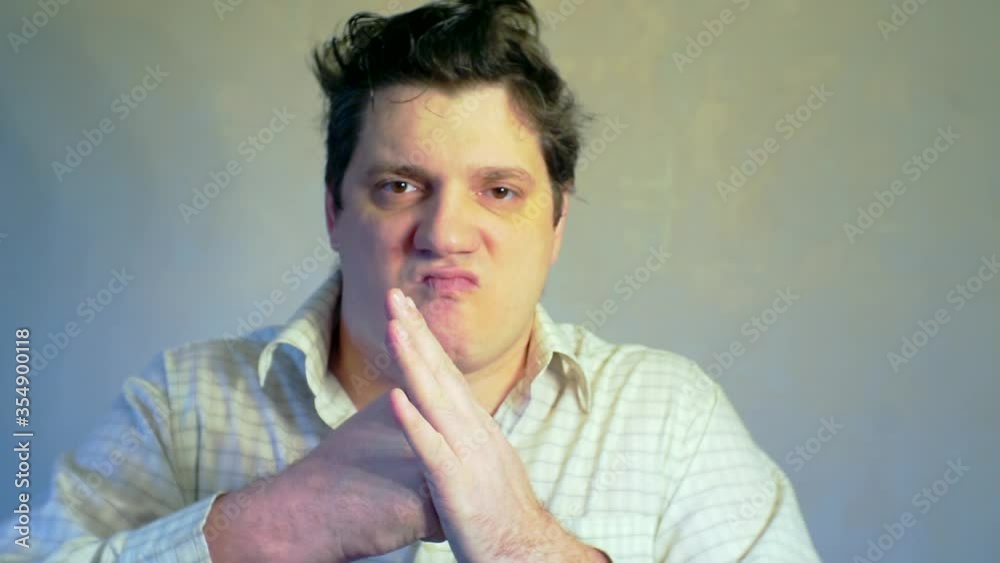 evil man who hit his fist in the palm of his hand. evil man who hit his fist in the palm of his hand.