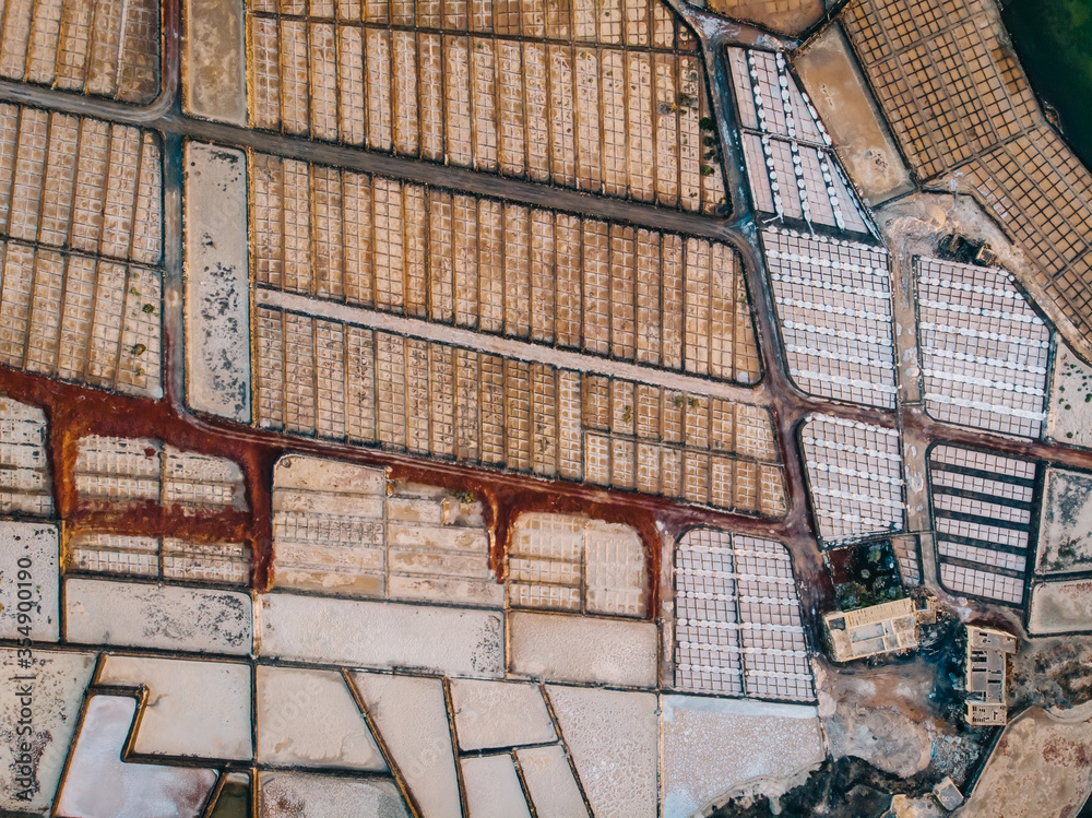Aerial view of saline pond and salt evaporation ponds filled from ocean salt crystals. Salt production. Lanzarote Island, Spain. Aerial view of saline pond and salt evaporation ponds filled from ocean salt crystals. Salt production. Lanzarote Island, Spain.