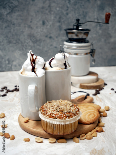 Spelled muffin, butter cookies, nuts and coffee with whipped cream and chocolate coating.