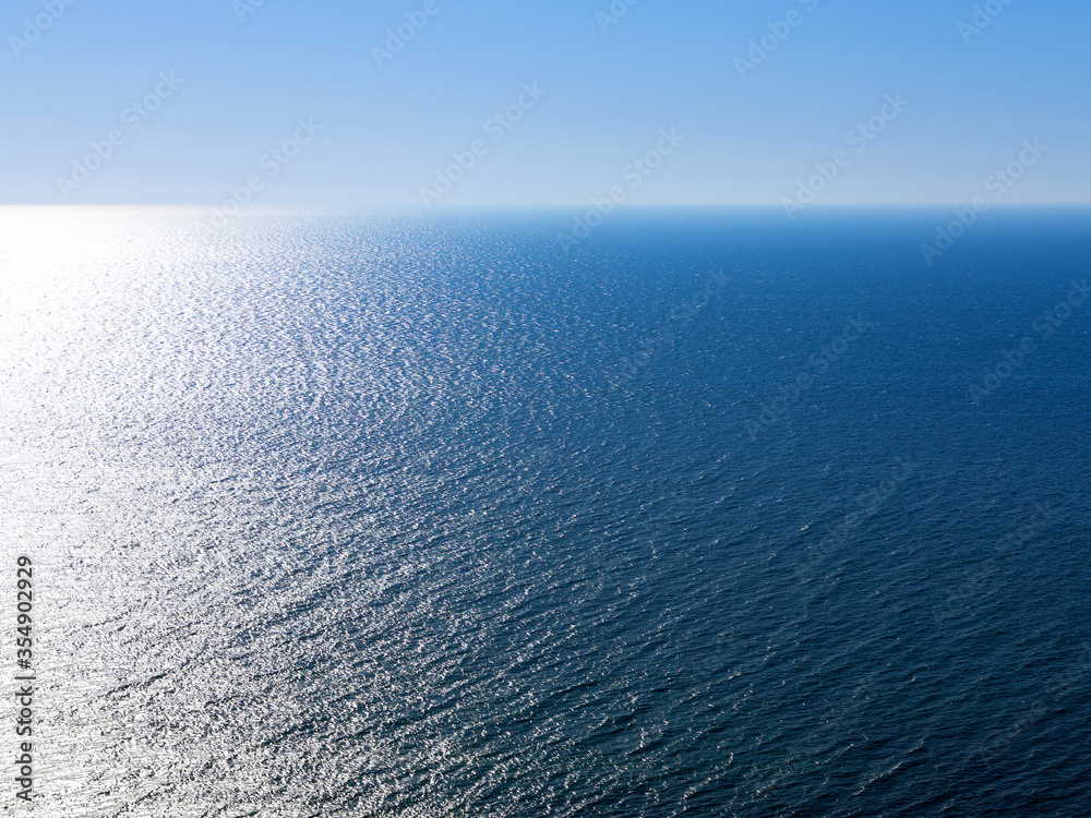 Blue landscape background sea surface backlit morning light of the setting sun in a wide range of brightness. For creative design Blue landscape background sea surface backlit morning light of the setting sun in a wide range of brightness. For creative design