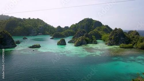 Piaynemo islands  in the Raja Ampat archipelago Indonesia with zipline cable, Aerial flyover reveal shot photo