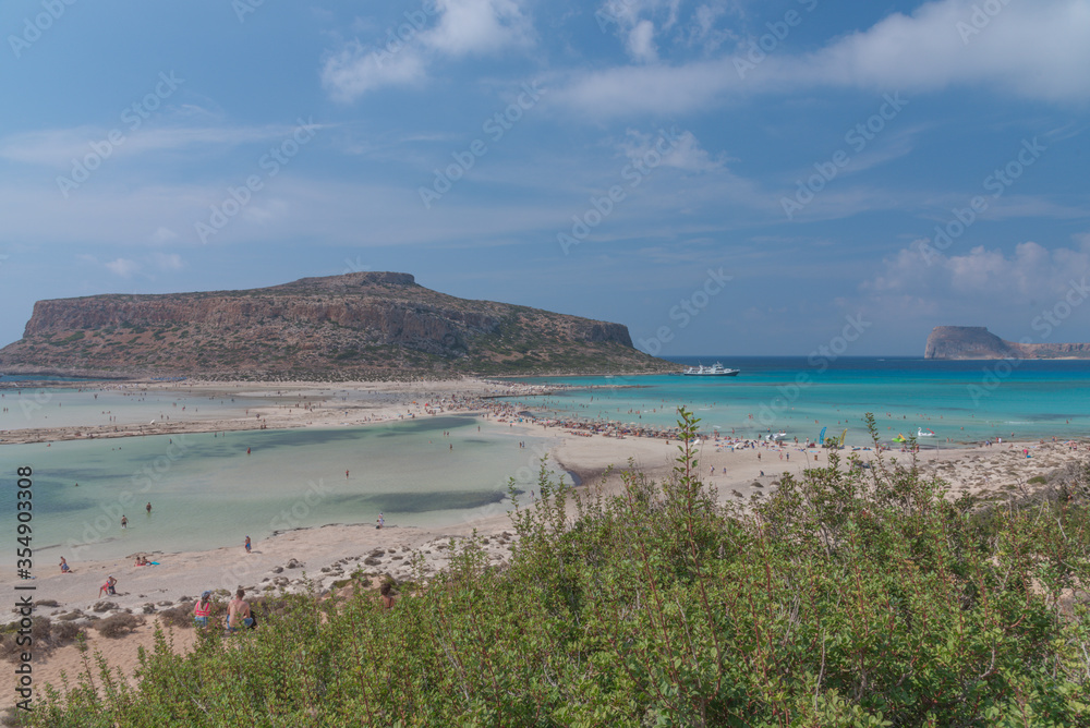 Amazing view of Balos Lagoon with magical turquoise waters, lagoons, tropical beaches of pure white and pink sand and Gramvousa island on Crete, Greece. Holiday concept