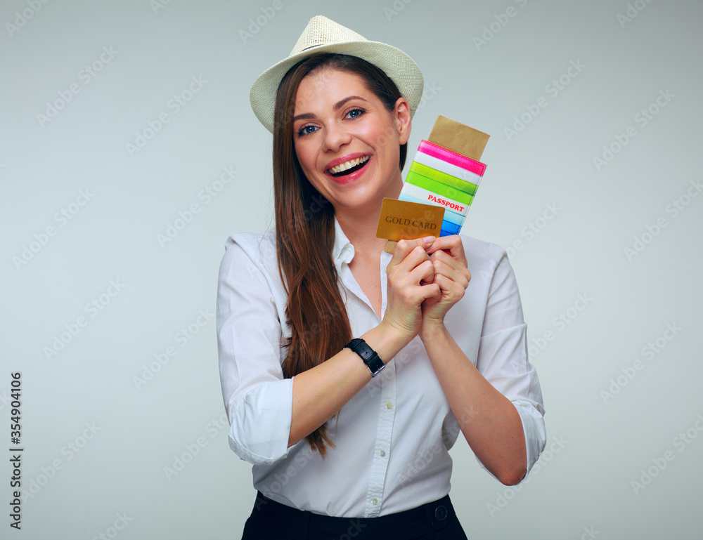 smiling woman holding credit card with passport and ticket. smiling woman holding credit card with passport and ticket.