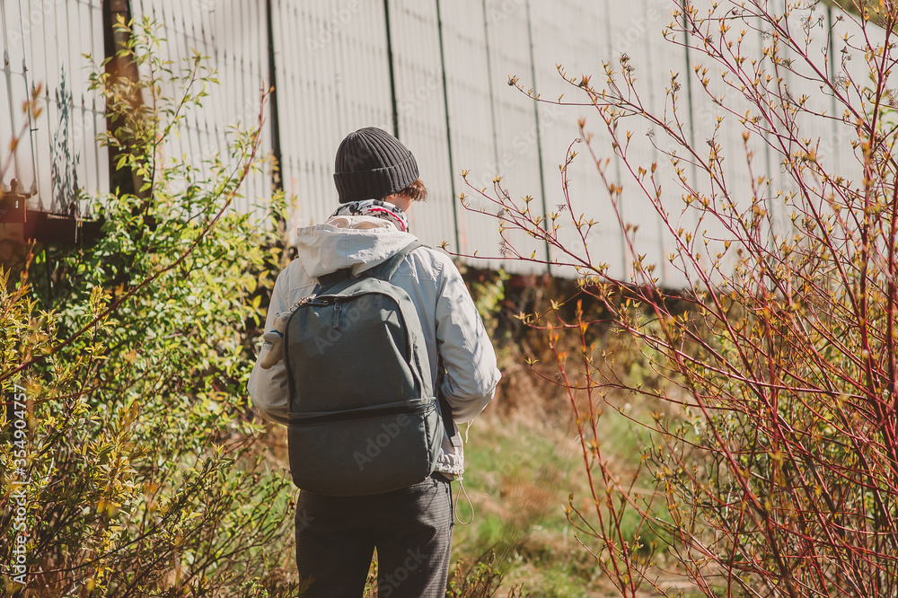 Naklejka premium A girl with a backpack goes into the wilderness. Going on an expedition in the North of Russia