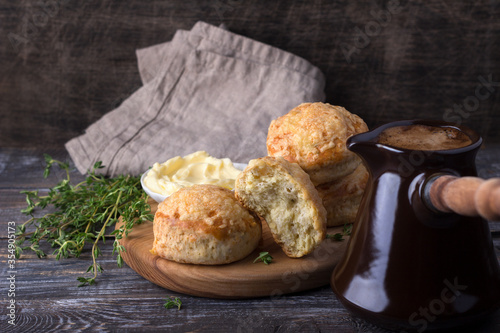 Photos Homemade freshly baked scones with cheese and herbs, turk coffee on wooden board on wooden table