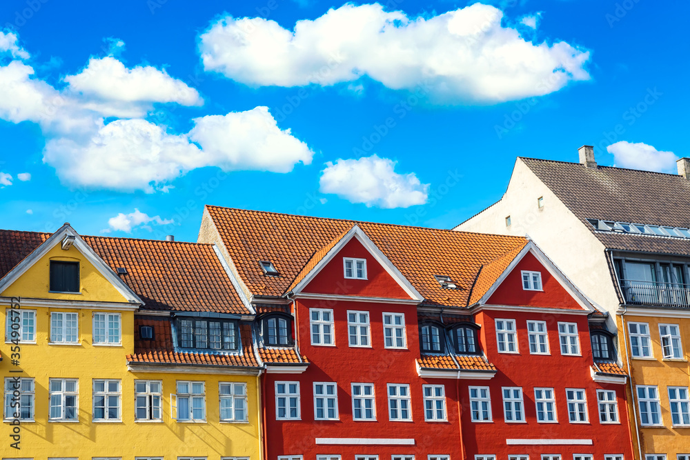 Copenhagen iconic view. Famous old colorful medieval houses in the center of Copenhagen, Denmark during summer sunny day. Nyhavn port Copenhagen iconic view. Famous old colorful medieval houses in the center of Copenhagen, Denmark during summer sunny day. Nyhavn port