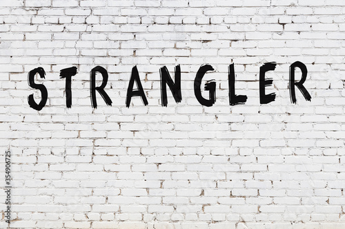 Word strangler painted on white brick wall photo