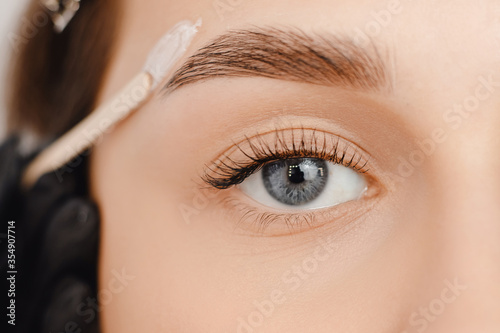 Master wax depilation of eyebrow hair in women, brow correction photo