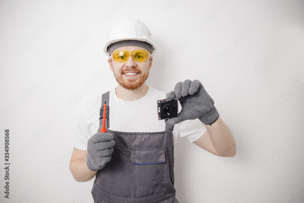 Electrician builder working switches and sockets of residential electrical system, black color