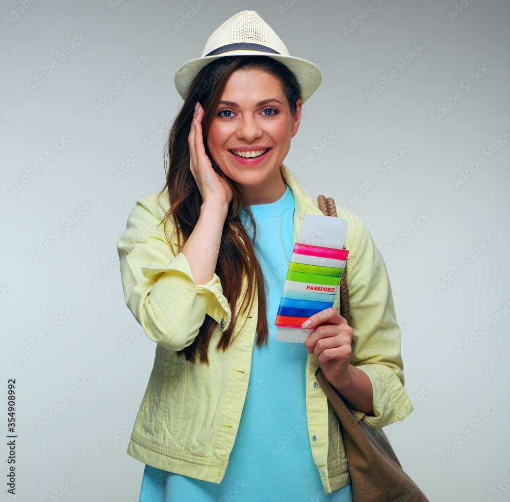 Smiling woman with handbag wearing blue dress and holding passport. Smiling woman with handbag wearing blue dress and holding passport.