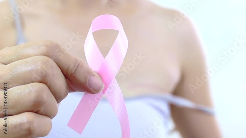 Pink ribbon with a breast cancer woman - A breast cancer survivor woman making a pink ribbon. Breast cancer surgery scars by partial mastectomy. Cancer awareness concept.