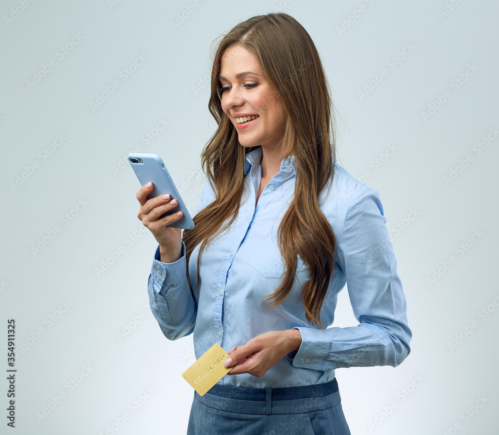 happy girl buys in an online store using credit card and smartphone. happy girl buys in an online store using credit card and smartphone.