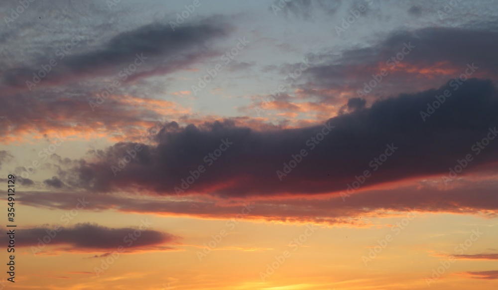 Beautiful orange sunset view with dark burgundy clouds