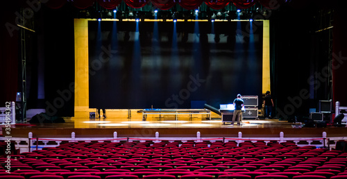 Concert or performance preparation. Red seats armchairs and the stage before concert.