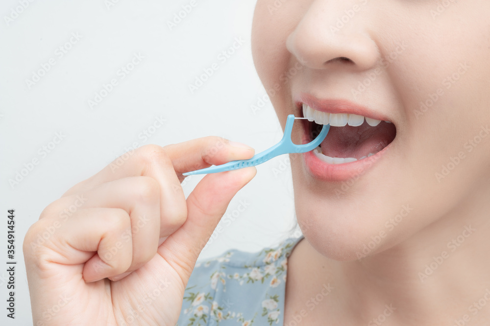 A Woman Cleaning Teeth With Dental Floss , Dental care , Tooth decay concept. A Woman Cleaning Teeth With Dental Floss , Dental care , Tooth decay concept.