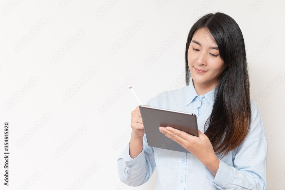 asian women read and thinking work new idea on tablet and holding pen. tecnology working concept. asian women read and thinking work new idea on tablet and holding pen. tecnology working concept.