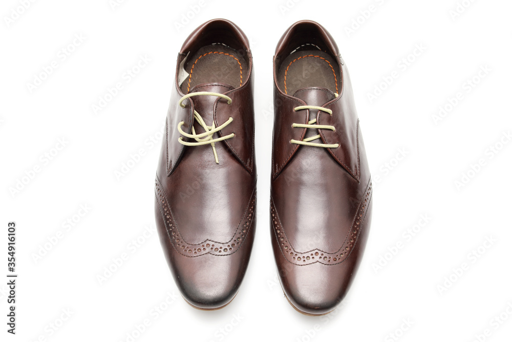 Two brown shoes with untied laces on a white isolated background Two brown shoes with untied laces on a white isolated background