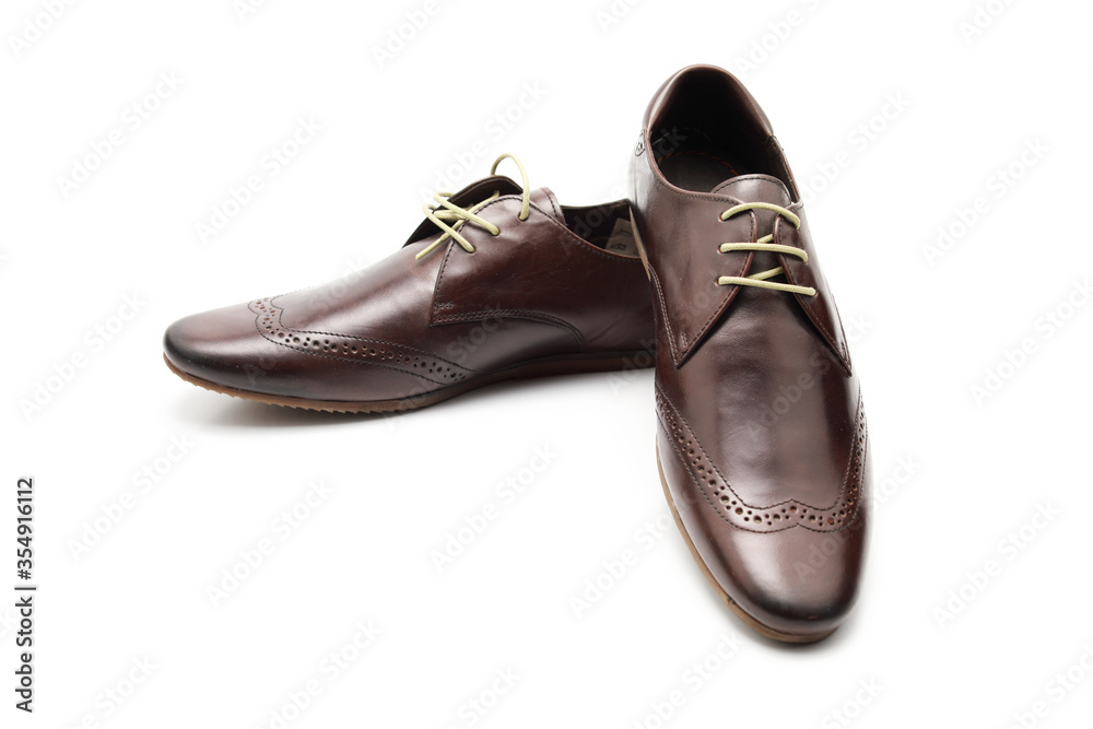 Two brown shoes with untied laces on a white isolated background