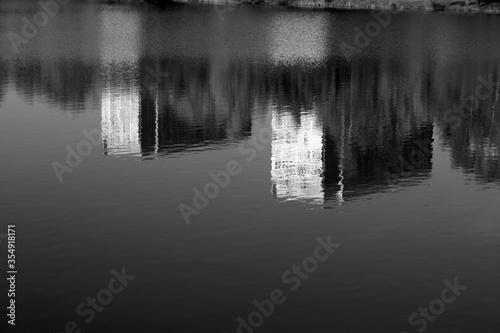 Residential buildings reflections in water. Black and white