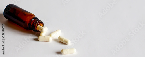 concept of medical pills in cup isolated on whte background. top view
