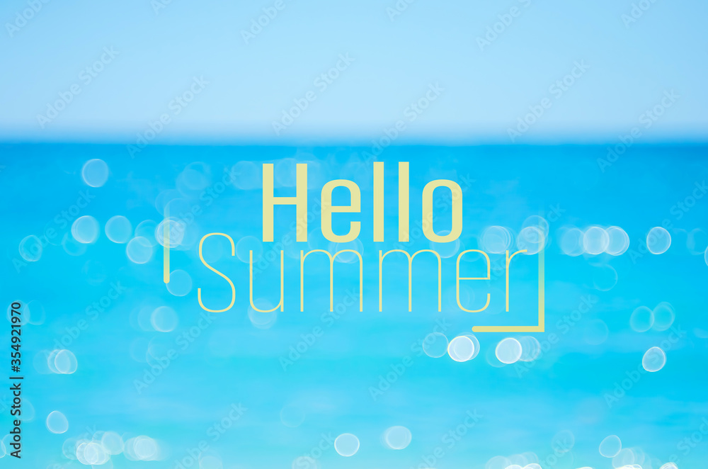 Hello summer words on blur tropical beach with bokeh sunlight wave abstract background. Summer vacation and travel holiday concept. Hello summer words on blur tropical beach with bokeh sunlight wave abstract background. Summer vacation and travel holiday concept.