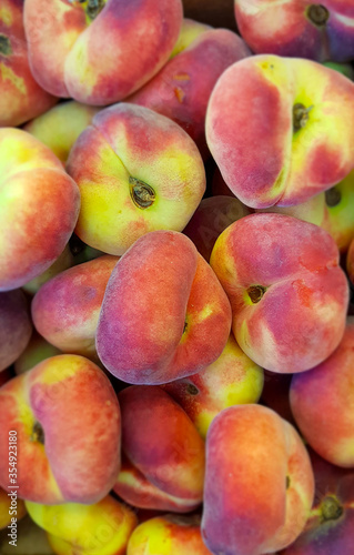 Saturn peaches on display at market.