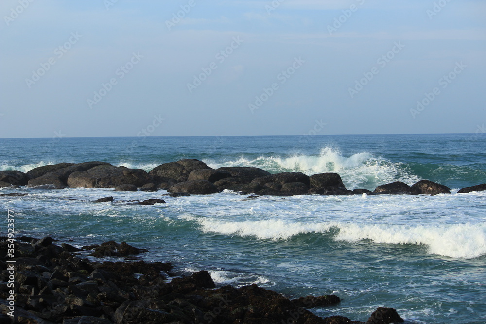 Beautiful Sea waves jumping over the rocks at Kanyakumari Beautiful Sea waves jumping over the rocks at Kanyakumari