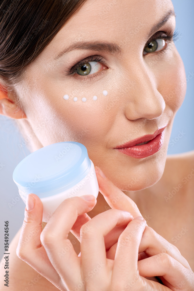 Face beauty portrait of woman with natural skin holding cream jar. Face beauty portrait of woman with natural skin holding cream jar.