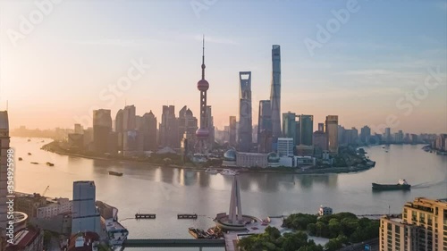 Time-lapse or Hyper-lapse Aerial View of Oriental Pearl Tower Financial District Pudong. Rising Up Shanghai Tower on the Bund Huangpu River. Ships Sail Around Downtown City Center above Waitan Puxi. photo