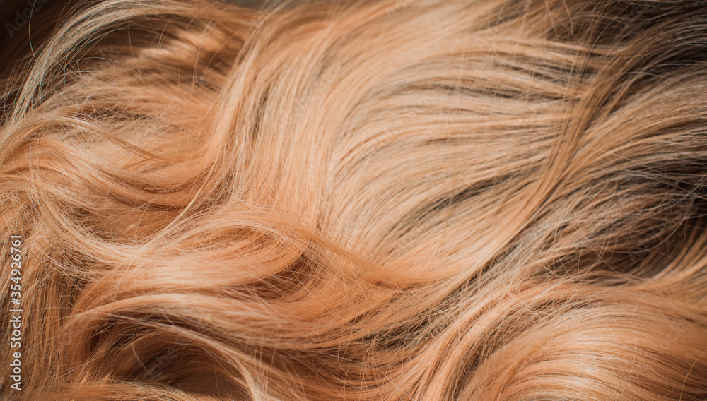 Wigs synthetic and natural hair. Light blown and blonde ombre hair. Womens beauty concept Wigs synthetic and natural hair. Light blown and blonde ombre hair. Womens beauty concept