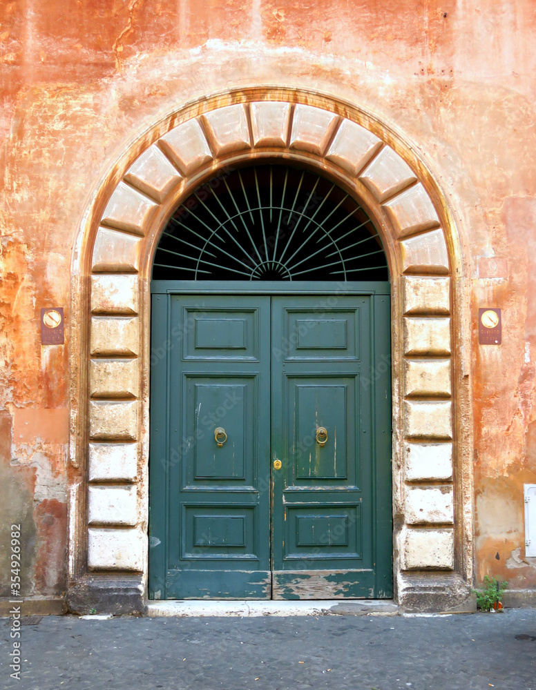 Old wooden door of a vintage house in Trastevere, Rome