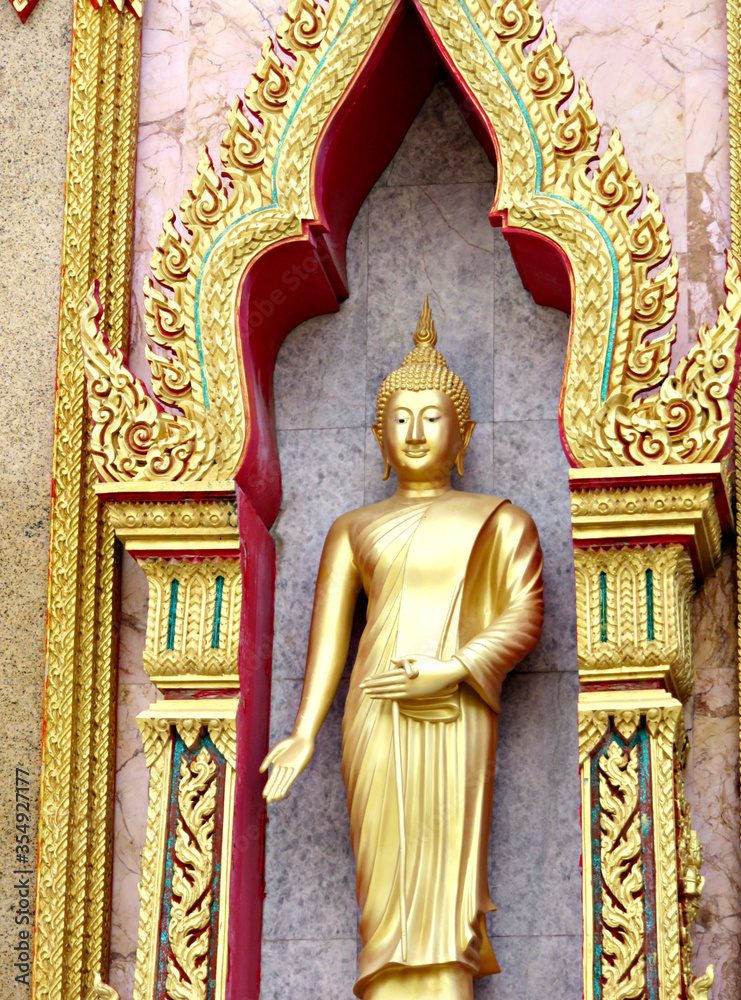 Close up of the golden statue of Buddha in a temple of Chalong in Phuket Thailand