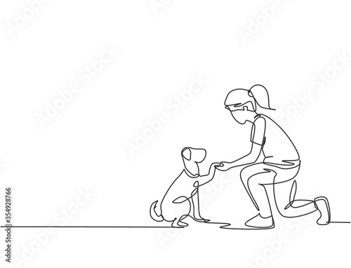 One line drawing of young happy girl handshaking her cute dog. Friendship about human and pet animal concept. Trendy continuous line drawing graphic vector illustration