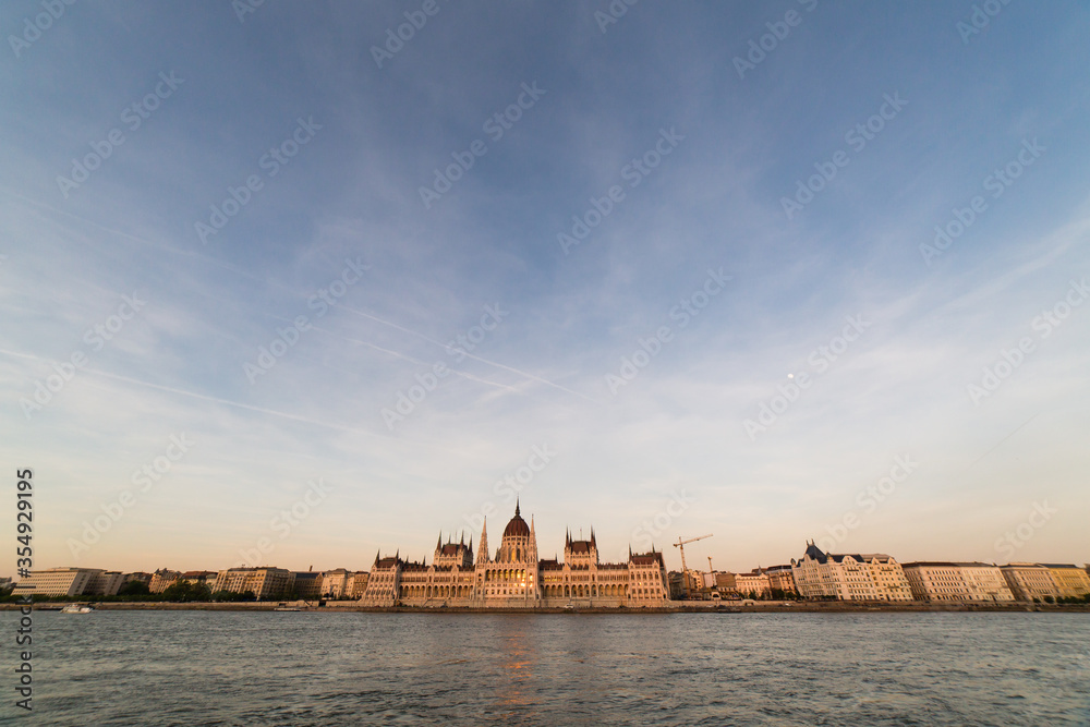 Budapest parliament building at sunset golden time with blue and Danube river