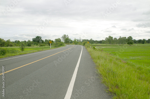 Countryside landscape, field and grass with in rural scenery with country road.