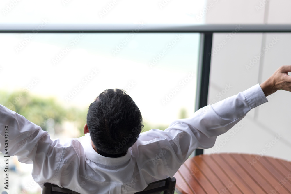 Fototapeta premium Good life and easy relax business man lifestyle after work at hotel sitting hands behind head for happy businessmen people.Simplify Your Life Week