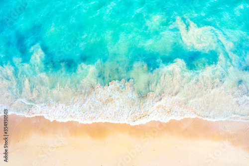Summer vacation background. Drone aerial view of turquoise ocean waves and the sandy coastline. Exotic tropical beach in Dominican Republic