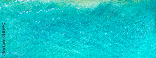 Summer vacation background. Drone aerial view of turquoise ocean. Banner format