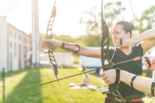 archery competition, woman preparing a bow and arrow to hit targets
