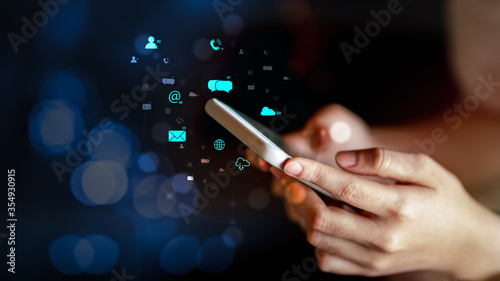 Woman using smartphone with multimedia digital icons