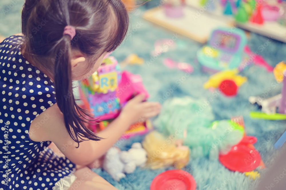 Close up Child little girl play toys disorderly mess in living room a dirty or untidy state of toy and doll at home Close up Child little girl play toys disorderly mess in living room a dirty or untidy state of toy and doll at home