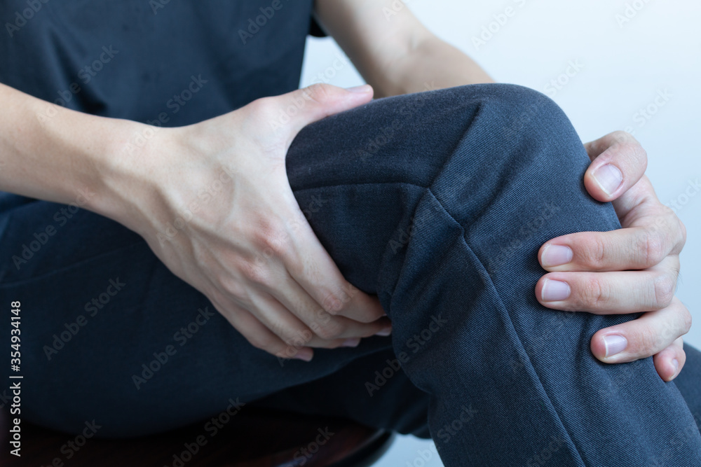 Knee pain after exercise concept. Man holds on his knee after knee
