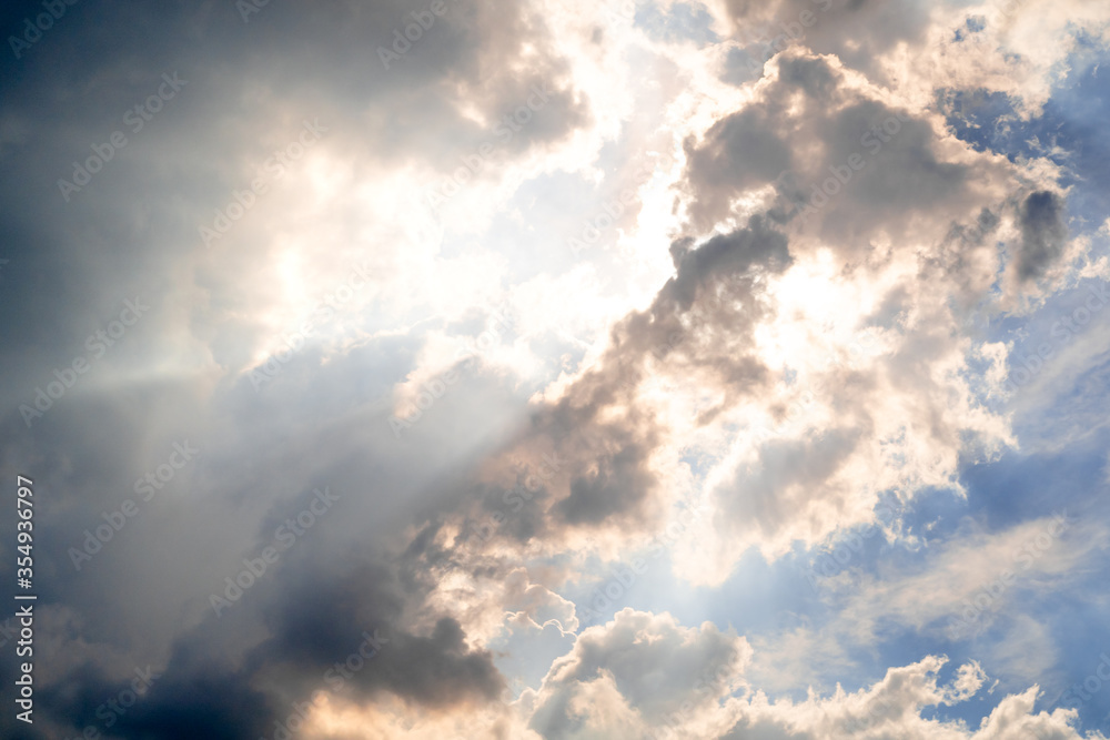 The sky with sunlight shining through the rain clouds. The sky with sunlight shining through the rain clouds.