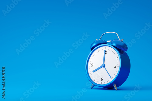 Blue alarm clock isolated on blue background with retro style. Classic analog clock and blank space. 3D rendering.