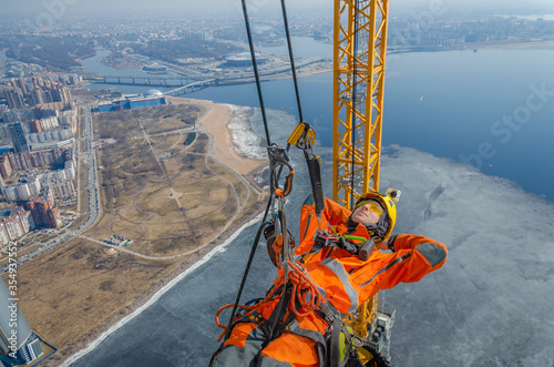 фотографія High-altitude installer resting at height