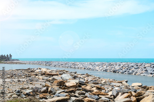 The breakwater or rock formation created to protect the beach.