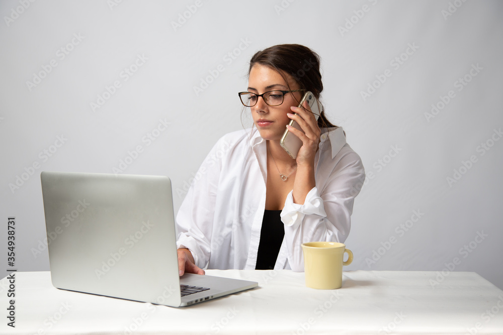 Young Model with glasses on computer in the office on a white background. Young Model with glasses on computer in the office on a white background.