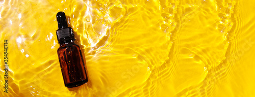 Wallpaper Mural Essential oil in water on a yellow background. The concept of aromatherapy. The preservation of the health, natural cures. Aromatherapy and perfumes concept Torontodigital.ca