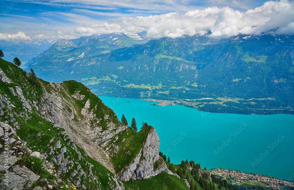 Panorama landscape of Swiss Alps with mountains, meadows and Lake Brienz. Taken at Hardergrat ridge trail / hike, Switzerland.