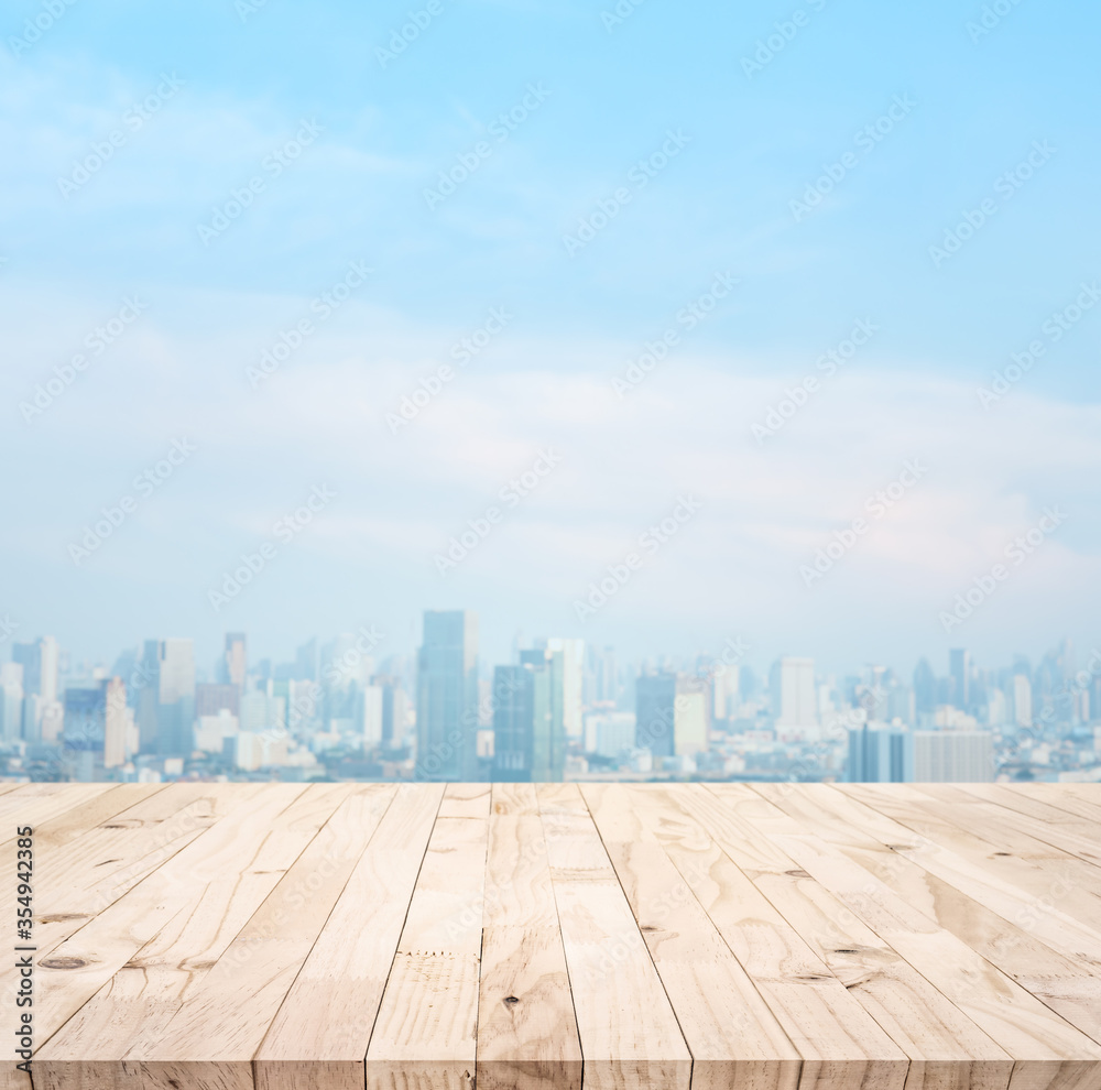 Wood table top on blur city view.For montage product display or design key visual layout